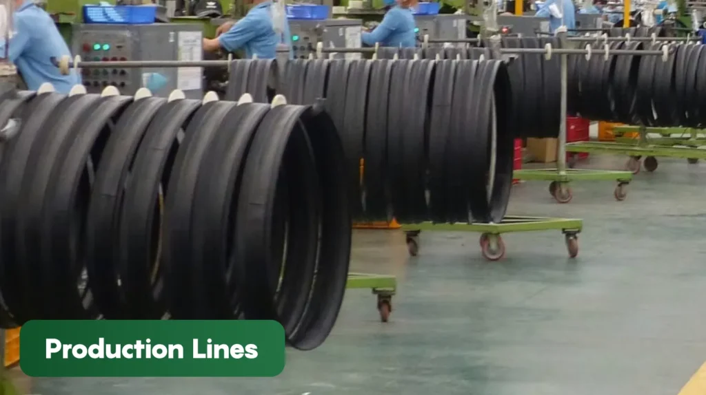 Bicycle tyre production line in a manufacturing facility showing multiple tyres moving through assembly and quality control processes during production.