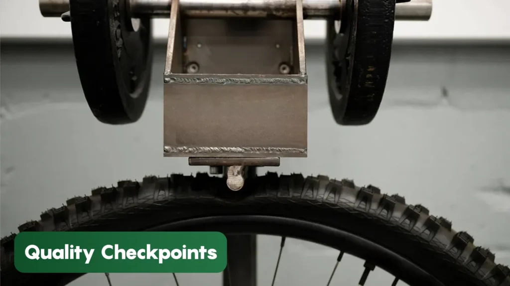 Bicycle tyre undergoing quality inspection at a manufacturing facility, demonstrating precision testing and quality control procedures during production.