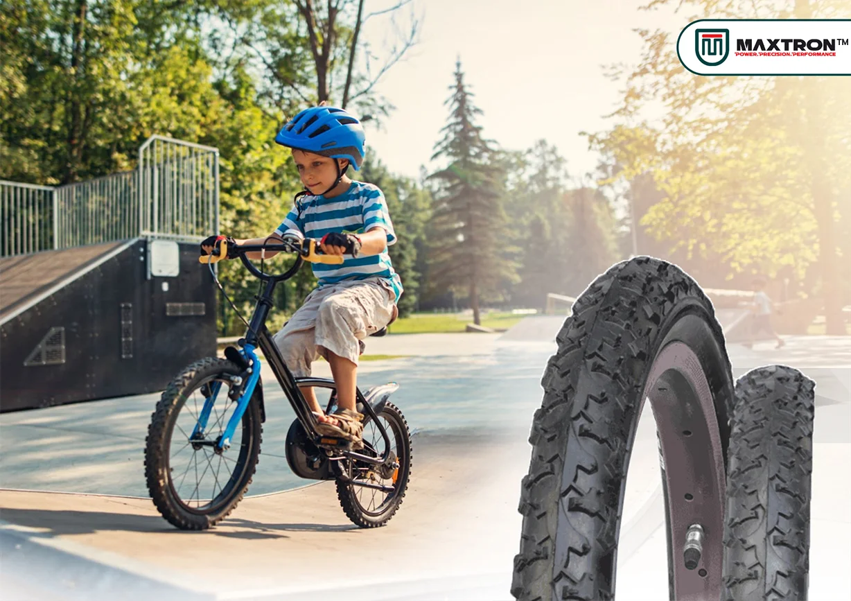 Child riding a BMX bicycle in a skate park with Maxtron BMX tyres displayed, showcasing durable and high-traction bicycle tires for kids' park and urban cycling.