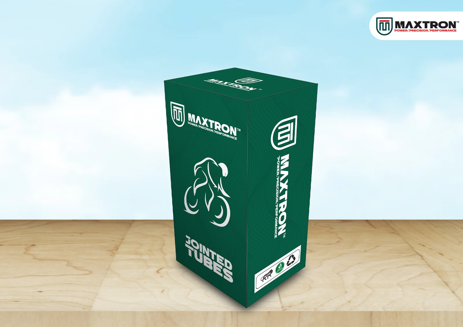 Green Maxtron Jointed Bicycle Tube box packaging displayed on a wooden surface, featuring bicycle graphics and premium branding for cycle inner tube products.