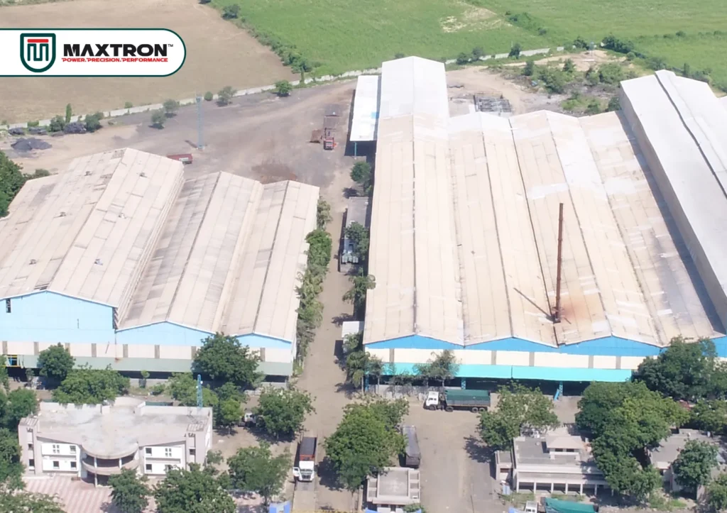 Aerial view of Maxtron manufacturing facility showcasing large industrial production units, operational infrastructure, warehousing areas, and expansive manufacturing campus.