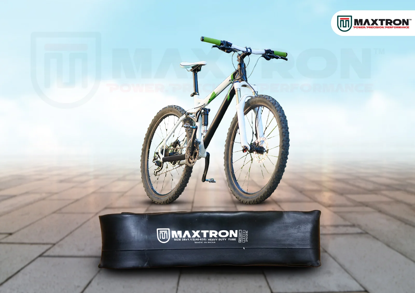 Mountain bike displayed above a Maxtron Jointed MTB Tube, highlighting a durable bicycle inner tube engineered for mountain biking and adventure cycling applications.