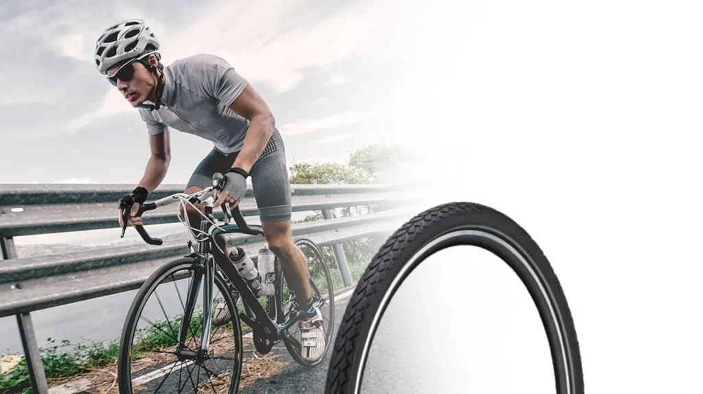 Cyclist riding a road bicycle alongside a premium radium bicycle tyre featuring reflective sidewalls for enhanced visibility, safety, durability, and road performance.