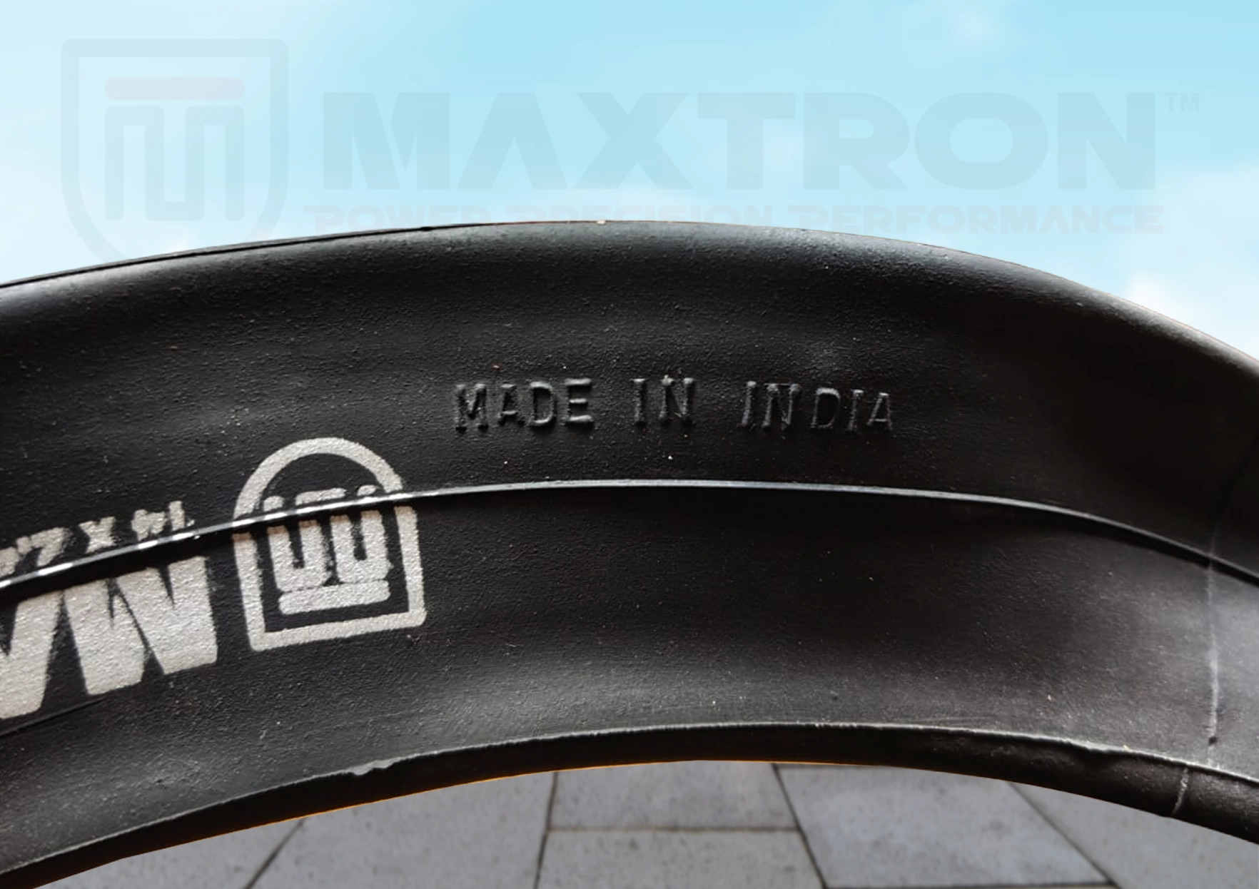 Close-up of Maxtron heavy-duty moulded bicycle tube with "Made in India" marking, showcasing premium rubber quality and precision manufacturing.